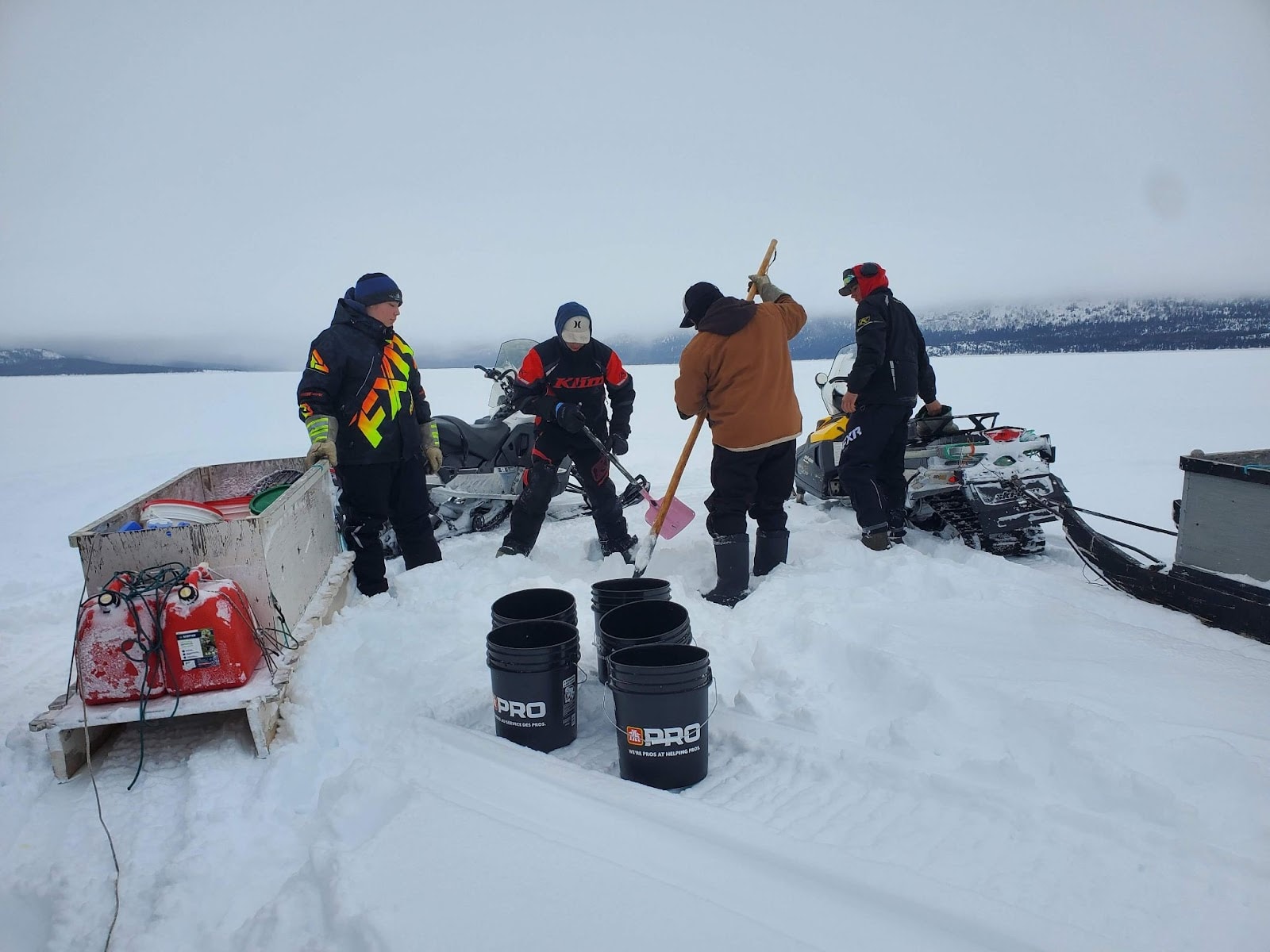 Inuit chiseling ice in Shapio Lake