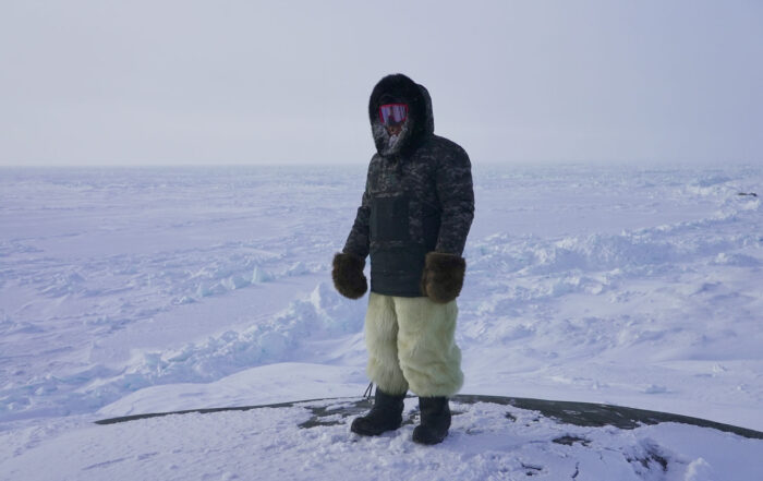 Paul Palliser wearing polar bear skin snowpants while on a hunt outside of Inukjuak, Nunavik