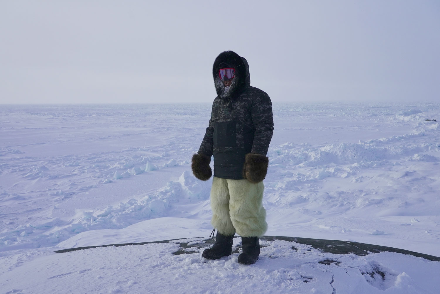 Paul Palliser wearing polar bear skin snowpants while on a hunt outside of Inukjuak, Nunavik